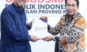 TEKS: Bupati Bengkalis diwakili Asisten Administrasi Umum Aulia serahkan Laporan Kepatuhan Standar Pelayanan Publik Pemerintah Kabupaten Bengkalis tahun 2023 kepada Kepala Perwakilan Ombusman RI Provinsi Riau Bambang Pratama.(Foto:informasiterpercaya.com)